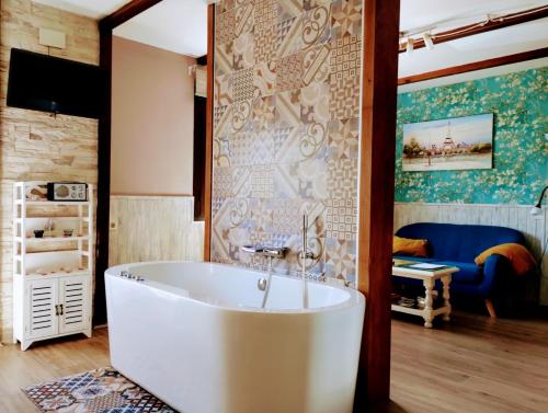 a bathroom with a large white tub in a room at Apartamento Rural Amaluna in El Torno