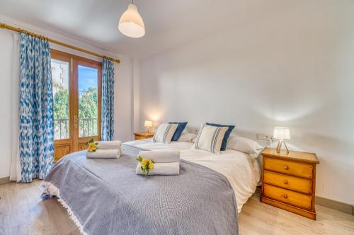 a bedroom with two beds and a window at Pins 441 Derecha in Playa de Muro