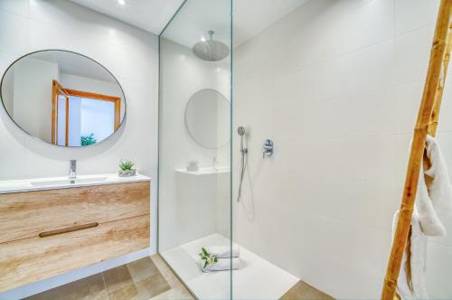 a bathroom with a shower and a sink and a mirror at Pins 441 Derecha in Playa de Muro