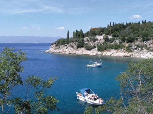 two boats floating in a large body of water at Apartman Hana u blizini Automotodroma Grobnik i Kostrenski plaža in Kostrena