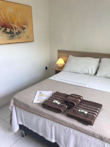 a hotel room with a bed with towels on it at AYRE GOSTOSO POUSADA in São Miguel do Gostoso