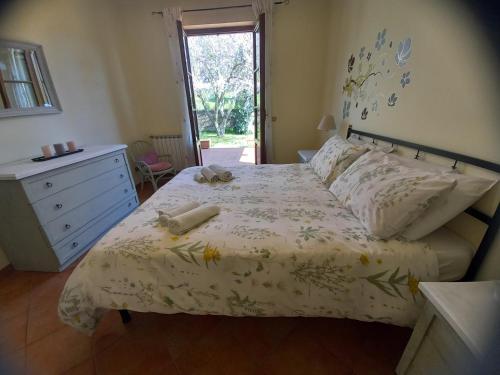 a bedroom with a bed and a dresser and a window at Il Parco holiday - locazione turistica in Fonte Nuova