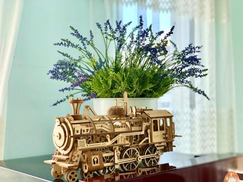 a wooden train planter with a potted plant at Deco Home @ Imago The Loft in Kota Kinabalu