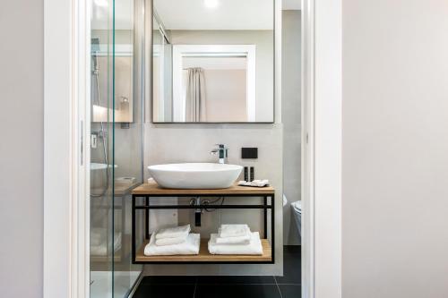 a bathroom with a sink and a mirror at Reflection Boutique Hotels in Toscolano Maderno