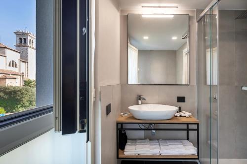 a bathroom with a sink and a mirror at Reflection Boutique Hotels in Toscolano Maderno