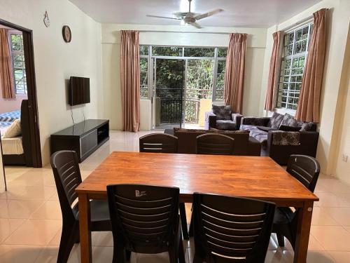 a living room with a wooden table and chairs at Mag Homestay at Crown Imperial Court, Brinchang in Cameron Highlands