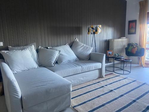 a living room with a white couch and a rug at La finestra sul castello in Sestola