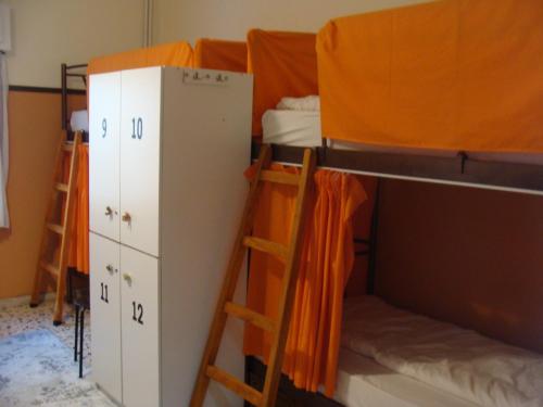 a dorm room with two bunk beds and a ladder at The Holy Rock - Hostel at meteora in Kalabaka