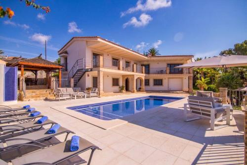 a villa with a swimming pool and a house at Luxury Villa Christine sea view in El Campello