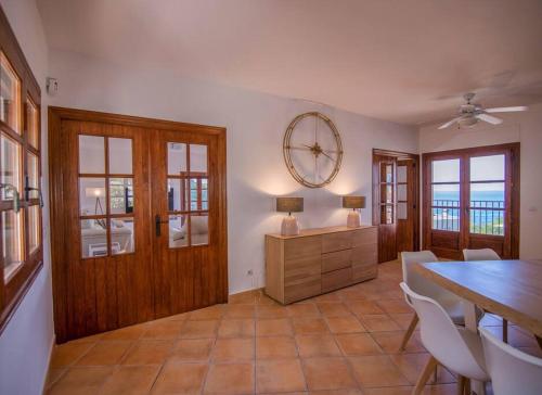 a dining room with a table and a mirror on the wall at Luxury Villa Christine sea view in El Campello