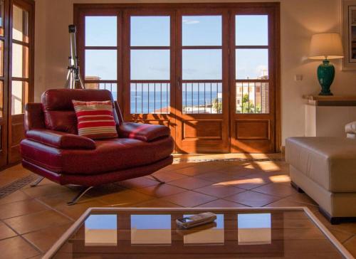 a living room with a chair and a coffee table at Luxury Villa Christine sea view in El Campello