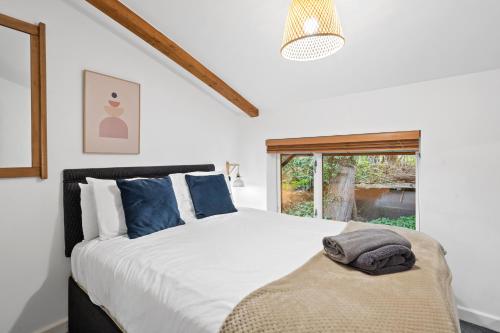 a bedroom with a large bed and a window at Tincroft Cottage - high end, luxury living near the beach in Truro