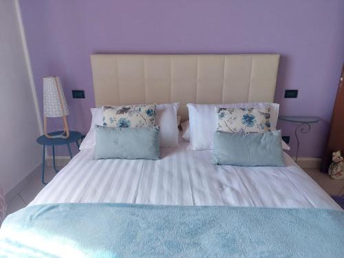 Elizabeth's House في ميراندولا: غرفة نوم بسرير كبير ومخدات زرقاء وبيضاء