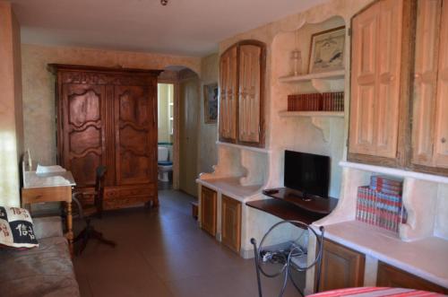 a living room with wooden cabinets and a television at Portman cosy in Toulon