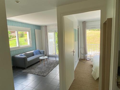 a living room with a couch and a chair at Pause Detente Sur La Port Du Bourget Du Lac in Le Bourget-du-Lac