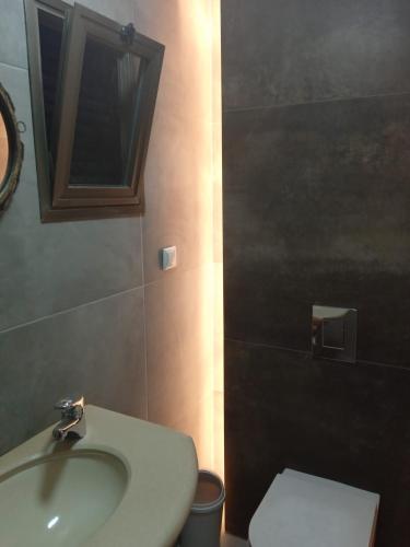 a bathroom with a sink and a toilet at Willa Sandal in Eilat