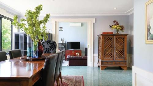 a dining room with a table and a living room at Akyra in Trentham