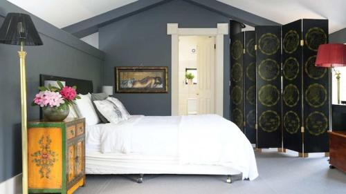 a bedroom with a white bed and blue walls at Akyra in Trentham