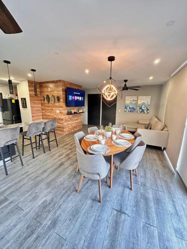 a dining room and living room with a table and chairs at Entire Luxurious Apartment in Shopping Mall in Mexico City
