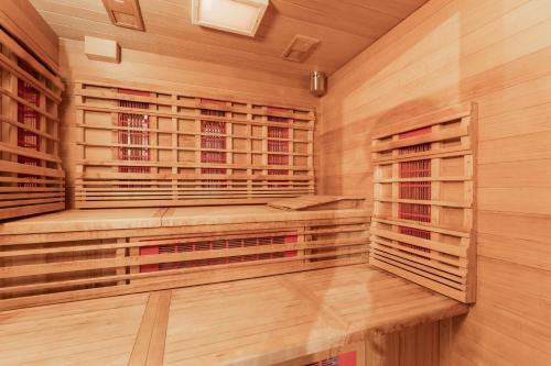 a sauna with wooden walls and wooden shelves at Aparthotel Ambiente in Umhausen