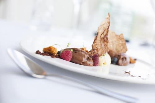 a plate of dessert on a table with a spoon at The Executive Inn, Newcastle in Newcastle