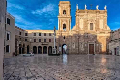 a large cathedral with a car parked in front of it at Santa Caterina in Brindisi