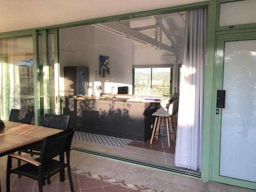 d'une salle à manger avec une grande porte coulissante en verre et une table. dans l'établissement Mazet Les Issambres / Ste-Maxime, à Roquebrune-sur Argens