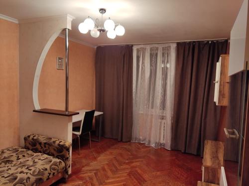 a living room with a couch and a table and a window at Комфортная квартира!!! in Tiraspol