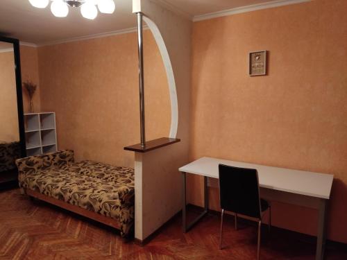 a room with a bed and a desk and a table at Комфортная квартира!!! in Tiraspol