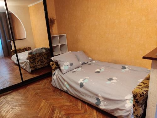 a bedroom with a bed with flowers on it at Комфортная квартира!!! in Tiraspol