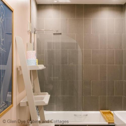 a bathroom with a shower with a toilet and a sink at Number 2 Steading Cottage in Banchory