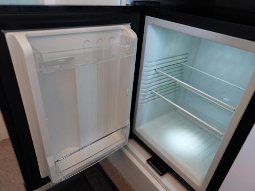 an empty refrigerator with its door open in a kitchen at Ellerhow in Windermere