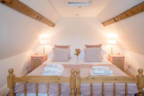 a bedroom with a large bed with two night stands at The Way Southwold in Southwold