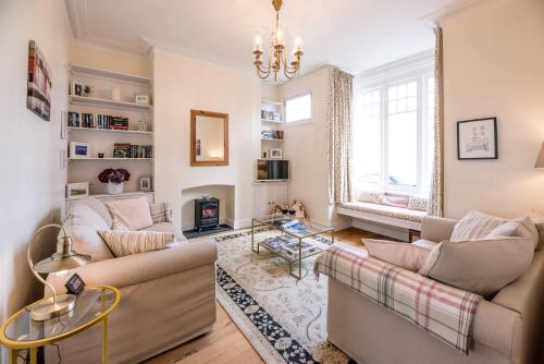 a living room with two couches and a fireplace at No 12, Southwold in Southwold