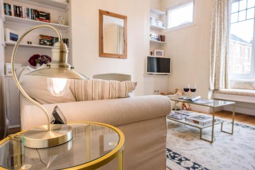a living room with a couch and a glass table at No 12, Southwold in Southwold