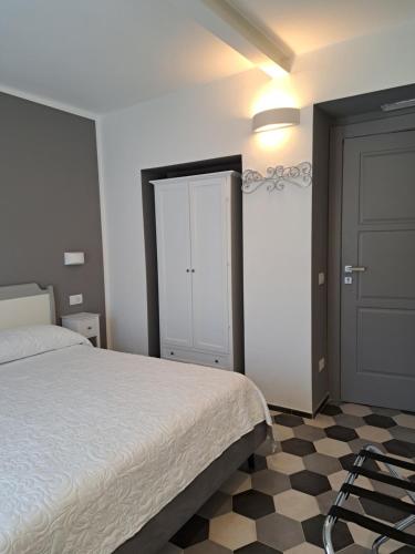 a bedroom with a bed and a door and a checkered floor at PAVIAN in Levanto