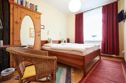 a bedroom with a bed and a large window at Zum Grünen Tor - ganzheitliche Pension in Görlitz