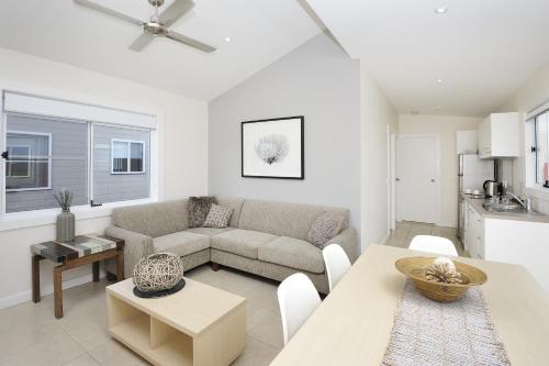 a living room with a couch and a table at NRMA Stockton Beach Holiday Park in Stockton