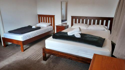 two beds in a hotel room at Homestay Family room, near the city center in Christchurch