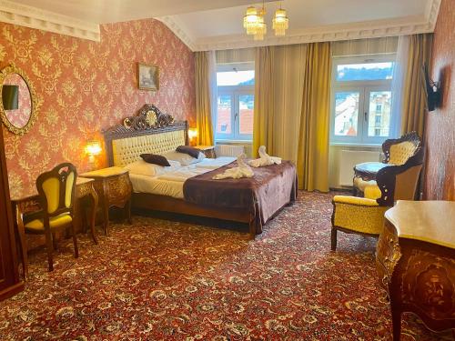 a bedroom with a bed and a table and chairs at Hotel Liliova Prague Old Town in Prague