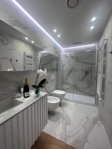 a bathroom with a shower and a toilet and a sink at About Italy Holiday Rooms and Apartments in Portovenere