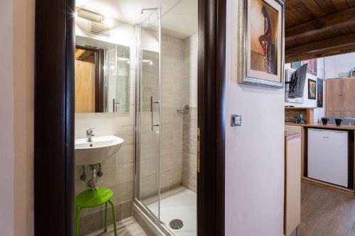 a bathroom with a glass shower and a sink at Appartamento Monti in Rome