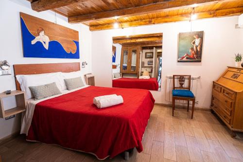 a bedroom with two red beds and a dresser at Appartamento Monti in Rome