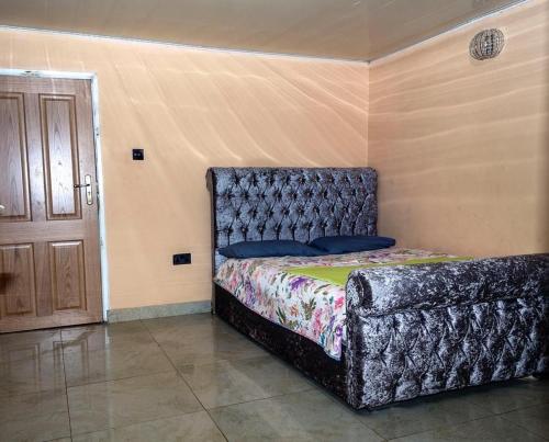 a bedroom with a bed in a room at M & B Residence in Freetown