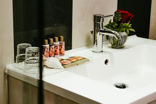 a bathroom counter with a sink and a mirror at Atlas Grand Hotel in Garmisch-Partenkirchen