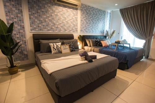 a bedroom with two beds and a couch at Ksl City Mall D'esplanade By The one in Johor Bahru