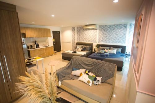 a living room with two beds and a couch at Ksl City Mall D'esplanade By The one in Johor Bahru