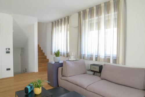 a living room with a couch and a table at Casa Riccardo in Levico Terme