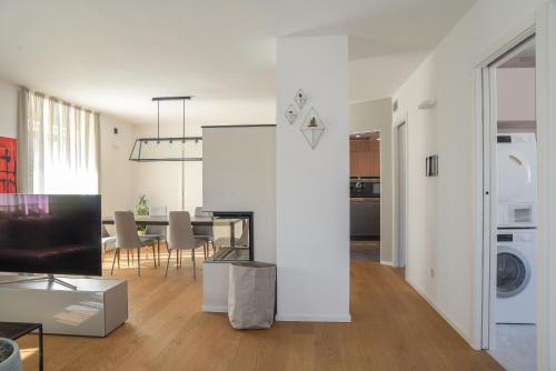a living room and dining room with a table and chairs at Casa Riccardo in Levico Terme