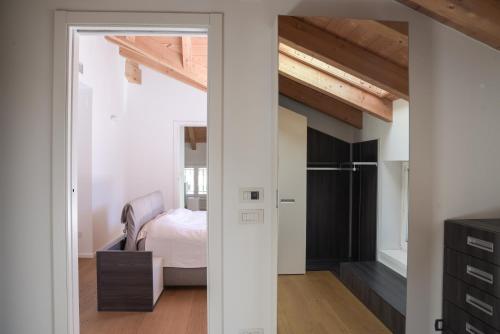 a bedroom with a bed and a door leading to a closet at Casa Riccardo in Levico Terme